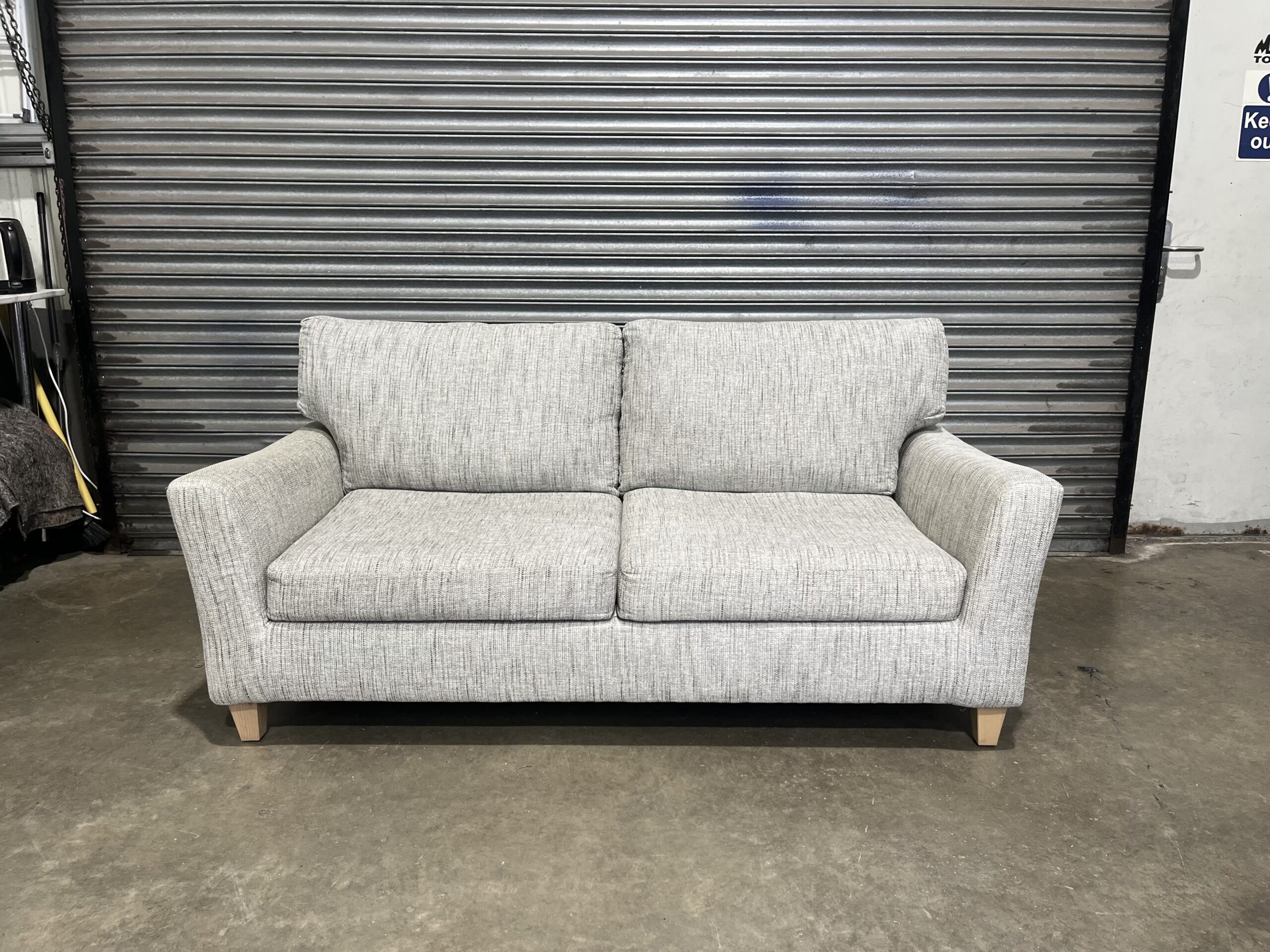 Beige two seater sofa.